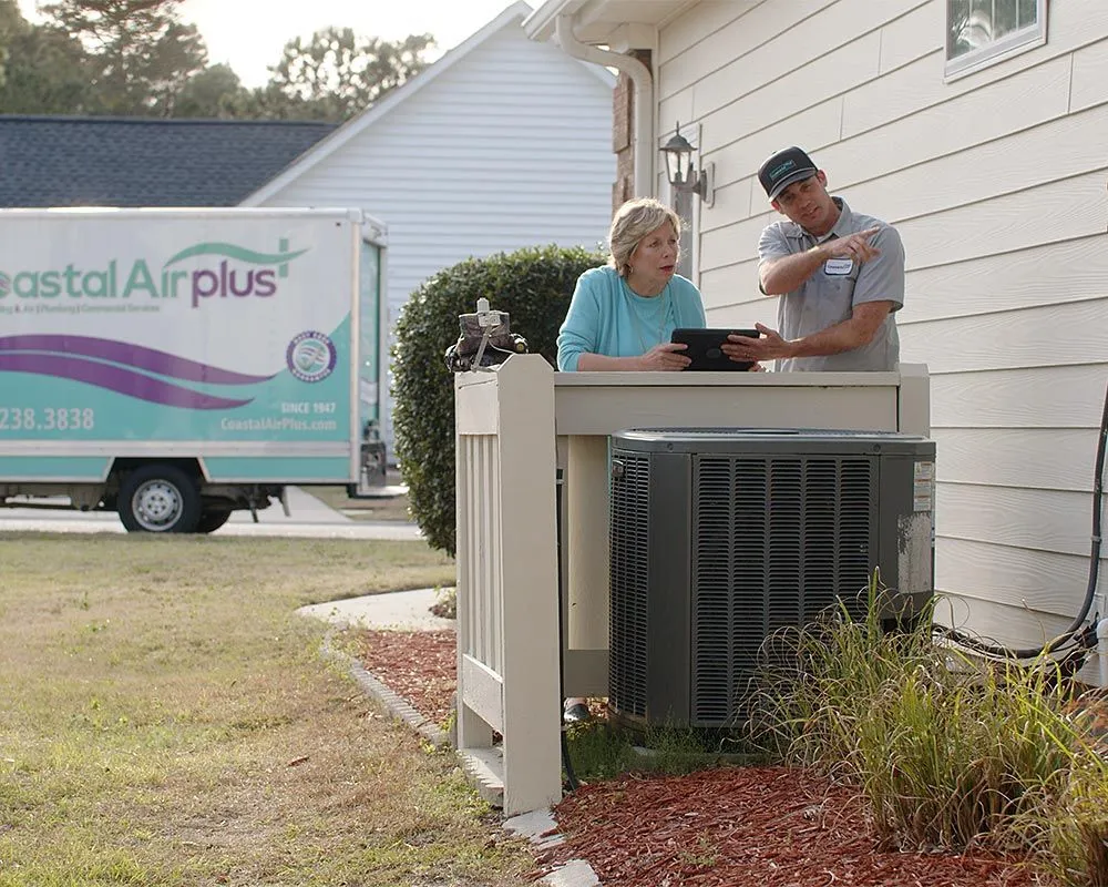 Coastal Air Plus technician walking a Charleston homeowner through the camera footage